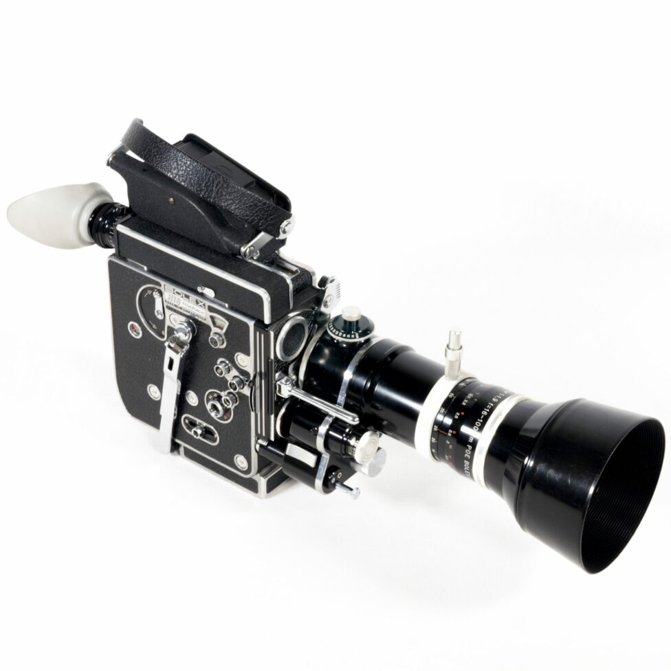 Three-quarter view of the camera from the front. The right side is visible. This entirely black camera features chrome elements. The body of the camera is on the left and the zoom lens is on the right.