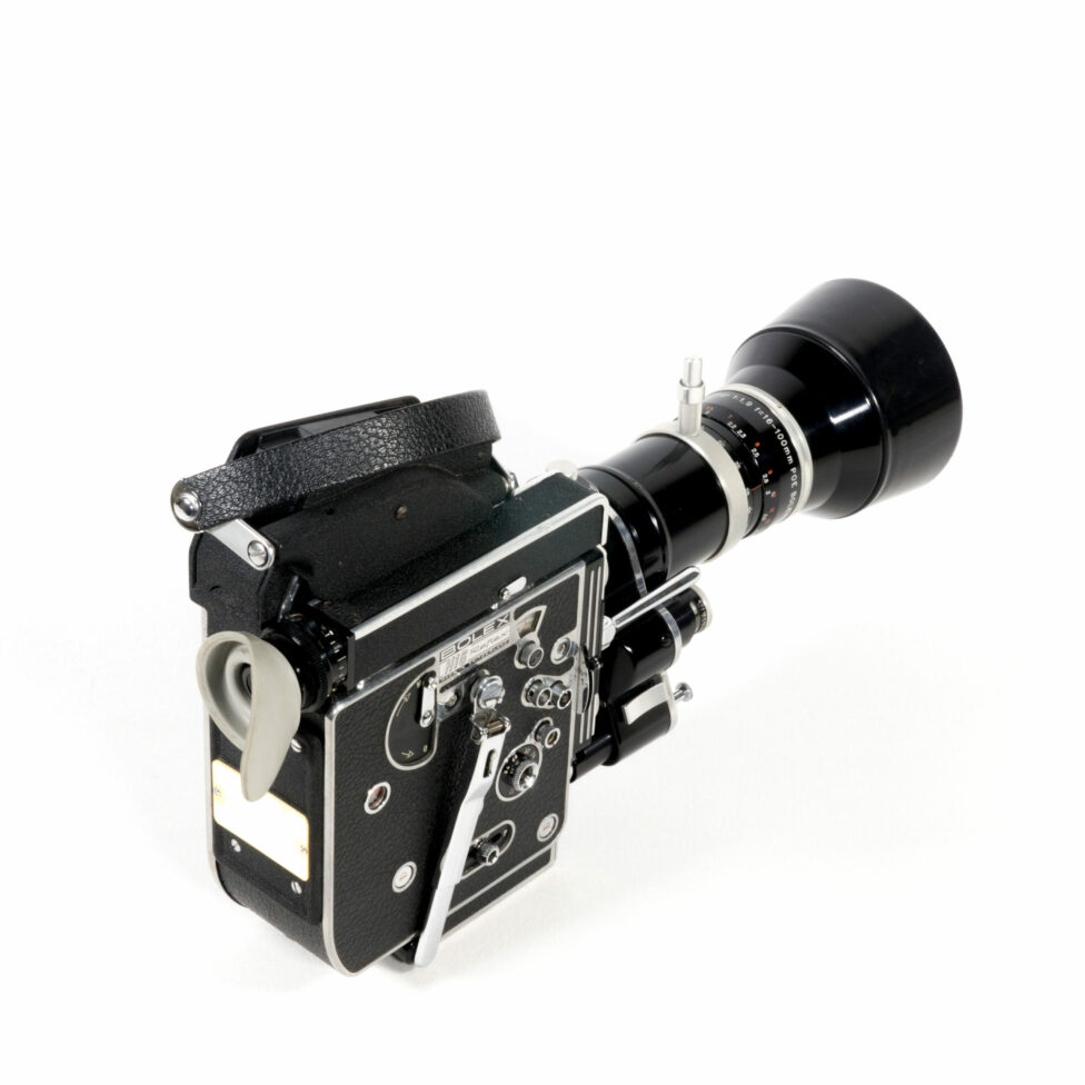 Three-quarter view of the camera from the rear. The right side is visible. This entirely black camera features chrome elements. The body of the camera is on the left and the zoom lens is on the right.