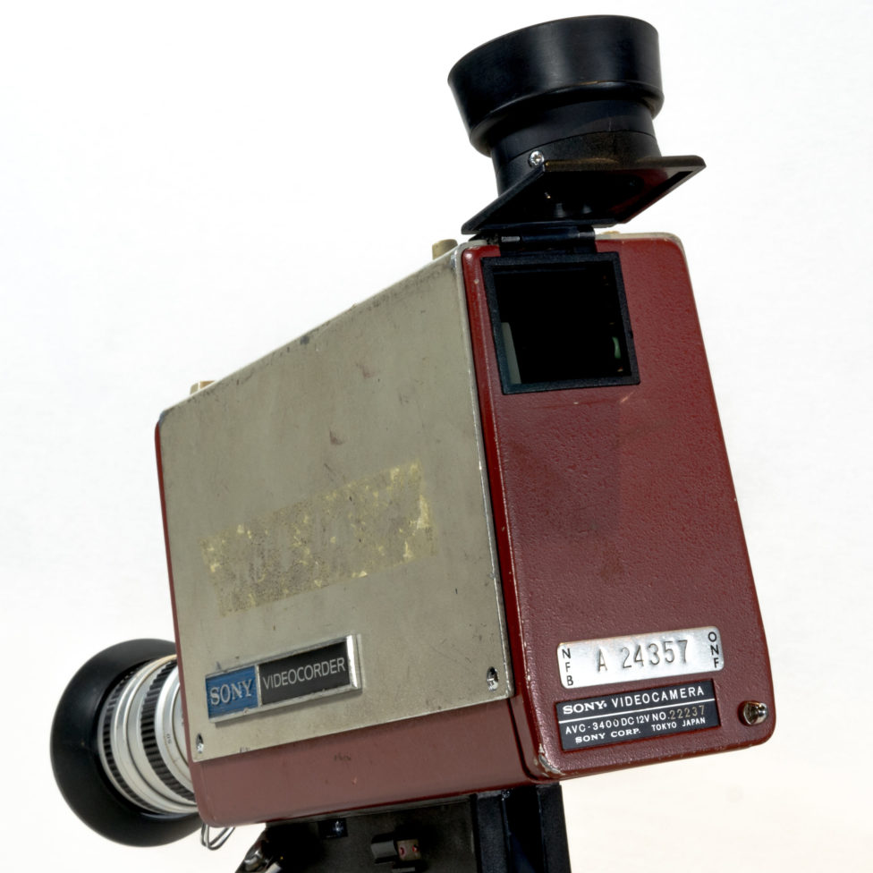Close-up of the rear of the camera. The viewfinder is raised, revealing a square-shaped opening.